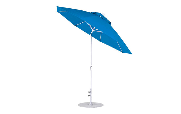 A 9 octagon blue Essential Fiberglass Umbrella by Ledge Lounger features a metal pole, round base, vented marine-grade canopy for air circulation and durability, and a crank auto-tilt mechanism combining style and functionality.