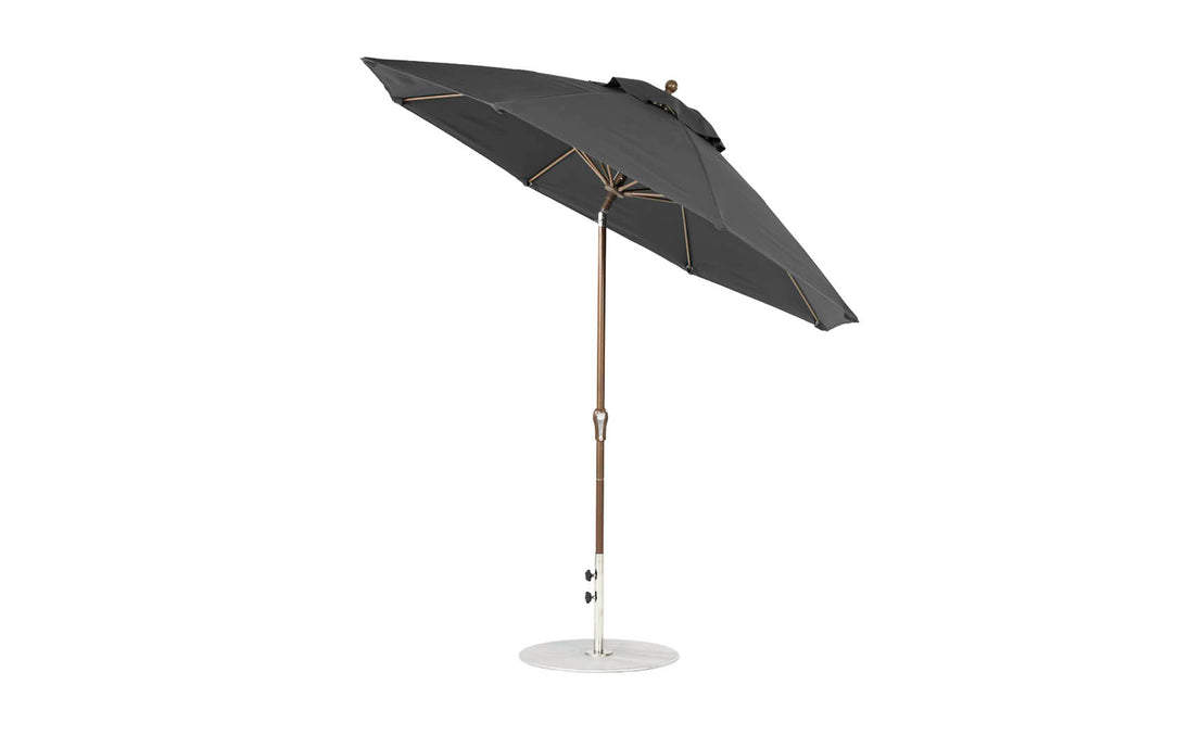 A 9 Octagon Crank Auto Tilt Essential Fiberglass Umbrella by Ledge Lounger features marine-grade fabrics, a black metal pole, and sturdy base. This sleek design includes a tilting mechanism and is displayed against a white background.