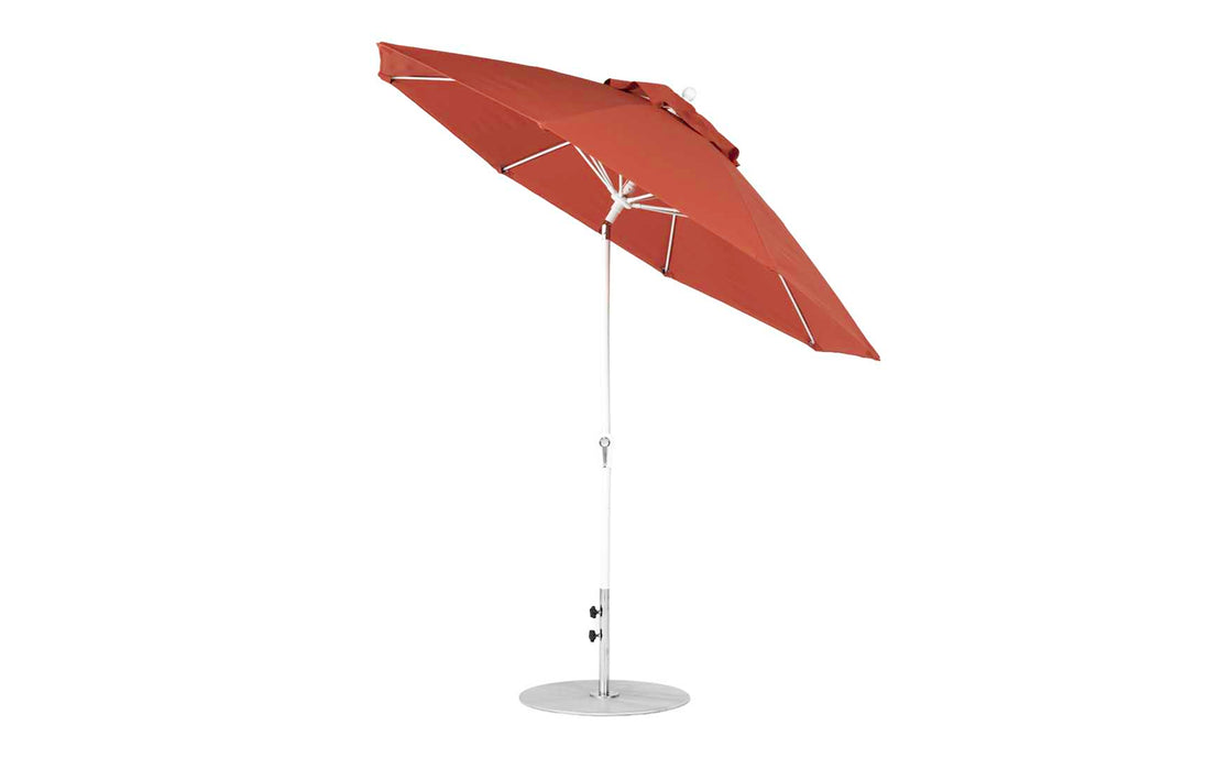 A brown 9 octagon Essential Fiberglass Umbrella from Ledge Lounger features a sturdy metal pole, circular base, marine-grade fabrics for durability, and a crank mechanism for easy tilting, opening, and closing.