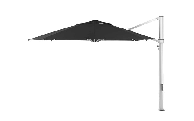 The Ledge Lounger Ultra Cantilever Umbrella - 13 Octagon, with its black canopy and metal pole, elegantly sits to the side of your patio. Its vast octagonal shape offers ample shade, while the rechargeable light ensures evening brightness.