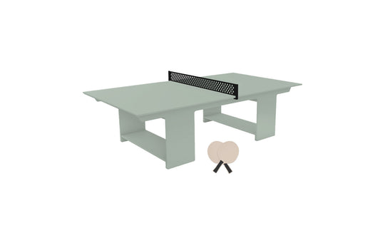 The Ledge Lounger Table Tennis Set features a light green table with a black net for outdoor fun. Two beige paddles are ready for play, and the modern block-style base adds a sleek touch to this inviting minimalist setup.