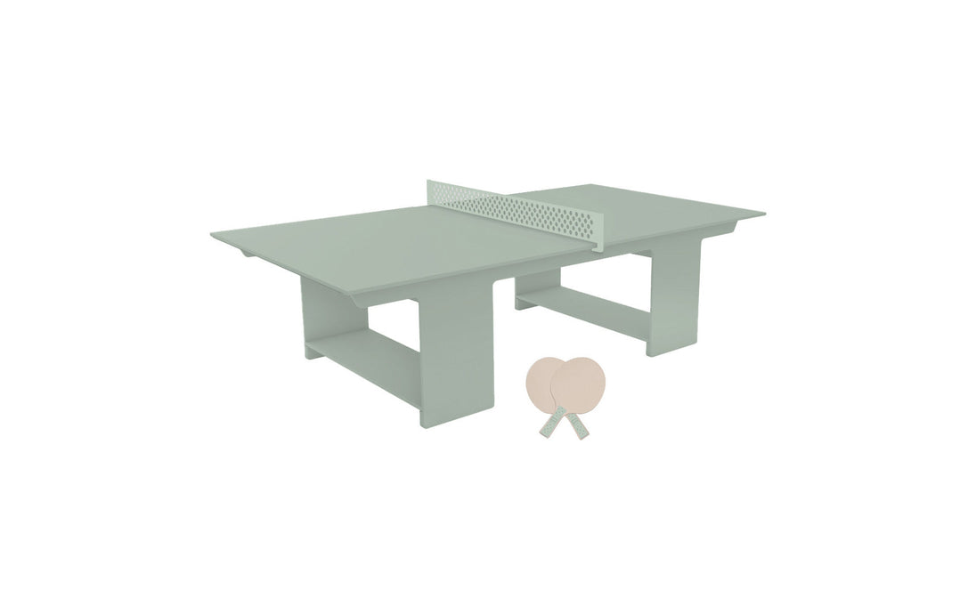 The Ledge Lounger Table Tennis Set in light green, with a perforated net and wooden paddles, is perfect for outdoor fun. Its minimalist design and pastel colors offer a modern aesthetic ideal for any ping pong fan.