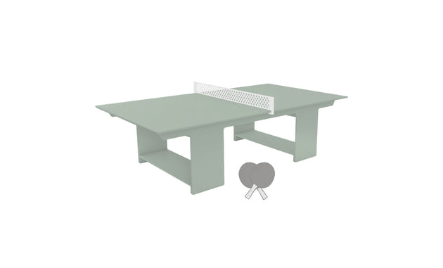 The Ledge Lounger Table Tennis Set is ready for outdoor fun with a light green surface and white net. Two gray paddles lie nearby, while sturdy rectangular legs provide stability for lively matches.