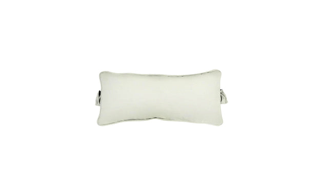 The Signature Headrest Pillow by Ledge Lounger, a rectangular pillow with slightly curved edges in a light color, rests on a white background. It features a small handle and casts a faint shadow, hinting at customizable options for relaxation in the pool.