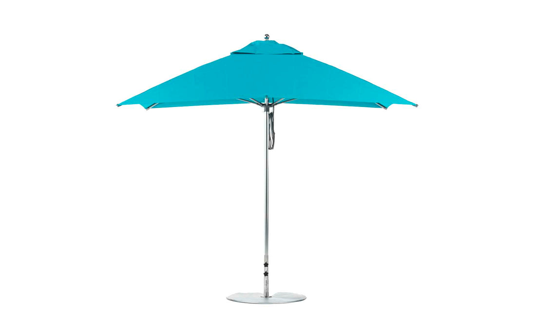 The Ledge Lounger Essential Fiberglass Umbrella features marine-grade blue fabric, a metallic pole with a circular base, and is fully open on a white background. This 8.5 rectangle pulley umbrella showcases its wind-resistant design without shadows.