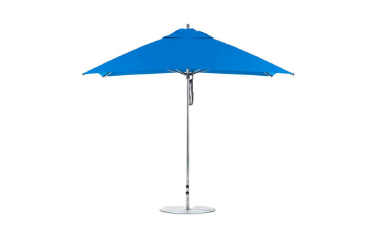 A blue Ledge Lounger Essential Fiberglass Umbrella with a silver pole and round base is open against a white background. The 8.5 rectangle pulley design features marine-grade fabrics and wind resistance for outdoor durability.