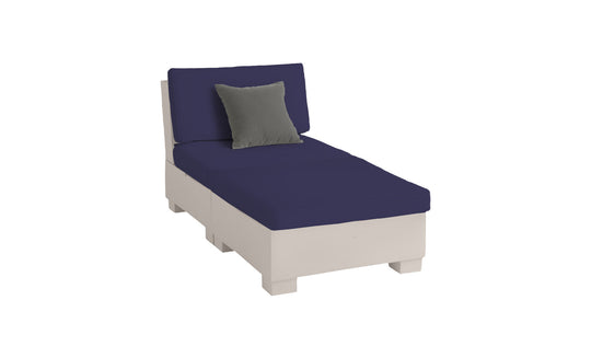 The Signature Sectional 2 Piece Sun Chair by Ledge Lounger features a cream frame, dark blue cushions, and a small gray pillow. Made from durable materials, it ensures sublime relaxation against a plain white background.