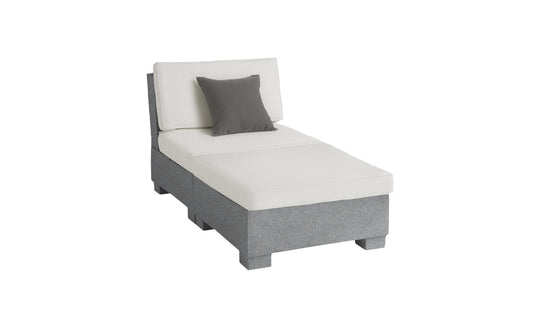 The Ledge Lounger Signature Sectional 2 Piece Sun Chair is a modern gray and white chaise lounge, featuring a dark gray accent pillow. It offers superior relaxation with its cushioned backrest and seat crafted from durable materials, supported by a sturdy base on a plain white background.