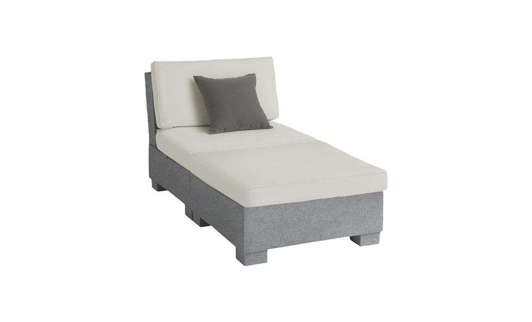 The Ledge Lounger Signature Sectional 2 Piece Sun Chair is a minimalist chaise lounge with light gray upholstery and a single dark gray pillow. It features a slightly angled backrest, clean lines, and a modern aesthetic for an elevated relaxation experience.