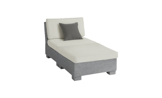 The Ledge Lounger Signature Sectional 2 Piece Sun Chair is a minimalist chaise lounge with light gray upholstery and a single dark gray pillow. It features a slightly angled backrest, clean lines, and a modern aesthetic for an elevated relaxation experience.