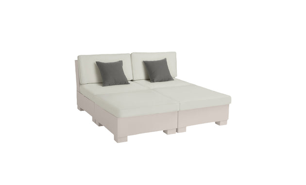 The Signature Sectional 4 Piece Sun Chair by Ledge Lounger offers spacious, modern seating and ultimate relaxation. This white modular sofa includes two grey accent pillows, features two backrests, a rectangular shape, and rests on small block feet for versatile arrangements.