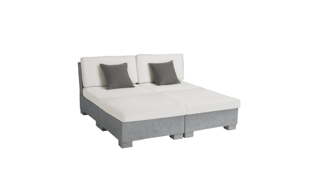 The Signature Sectional 4 Piece Sun Chair by Ledge Lounger is a modern modular sofa with spacious seating, consisting of two sections. Each section features white upholstered cushioned seats and backrests with gray fabric bases, complemented by two square gray pillows for relaxation.