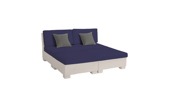 The Signature Sectional 4 Piece Sun Chair by Ledge Lounger has a cream base with navy cushions, two backrests, and two gray throw pillows. It offers spacious seating or can be arranged as a bed, seen on a white background. Perfect for relaxation.