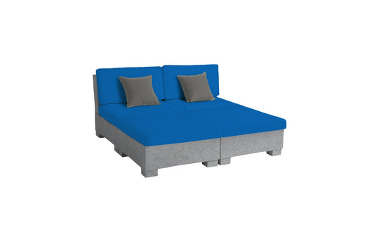 The Signature Sectional 4 Piece Sun Chair by Ledge Lounger offers a contemporary look with a modern, low-profile gray base and vivid blue seating. It includes two small gray pillows and is set against a plain white background, providing a relaxing and minimalistic aesthetic.