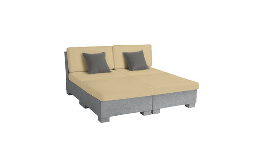 The Signature Sectional 4 Piece Sun Chair by Ledge Lounger features a modular design with beige cushions, gray base, and two gray throw pillows. Resembling two conjoined lounge chairs, it provides spacious seating for relaxation.
