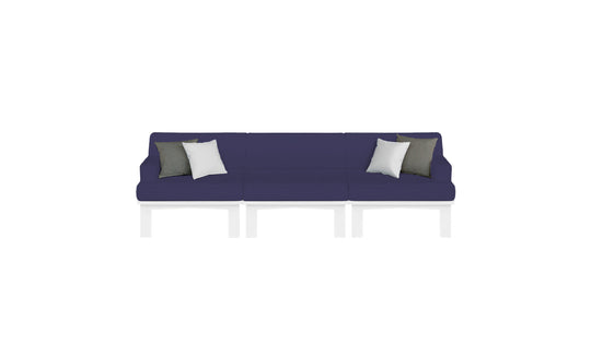 The Mainstay Sectional 3 Piece Sofa by Ledge Lounger is a long, dark blue sectional with three sections and white legs. It features two white and two dark gray throw pillows symmetrically placed against a plain white background.