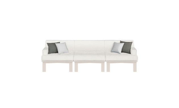The Ledge Lounger Mainstay Sectional 3 Piece Sofa, with a modern white design and wooden legs, adds style to outdoor spaces. It includes two dark gray pillows and one light gray pillow, all set against a plain white background.