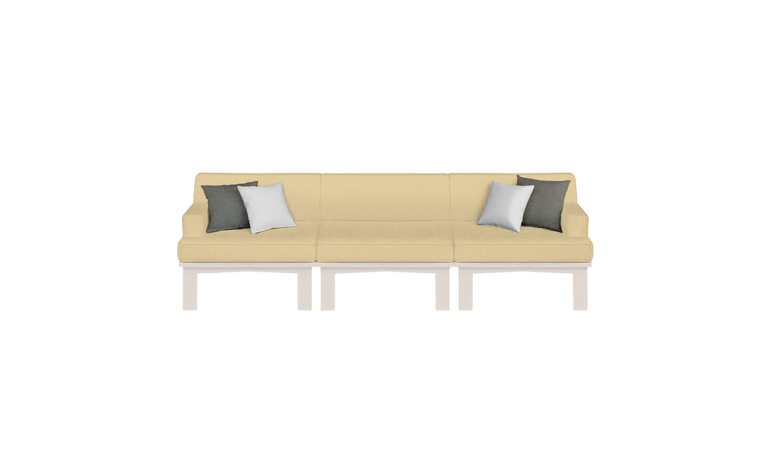 The Mainstay Sectional 3 Piece Sofa by Ledge Lounger is cream-colored with three seats on a white base. It features two dark green and two light gray pillows, making it perfect for enhancing outdoor spaces with its elegant simplicity against any white background.