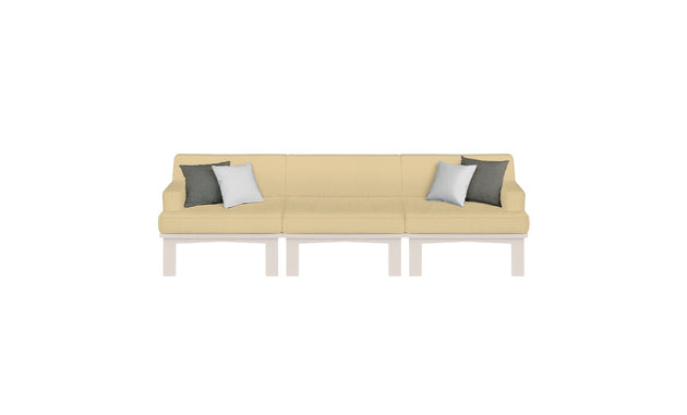 The Mainstay Sectional 3 Piece Sofa by Ledge Lounger is cream-colored with three seats on a white base. It features two dark green and two light gray pillows, making it perfect for enhancing outdoor spaces with its elegant simplicity against any white background.