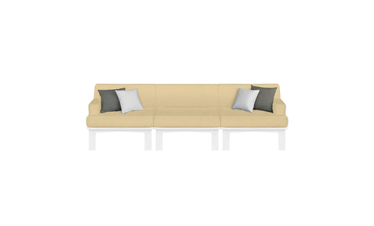 The Mainstay Sectional 3 Piece Sofa by Ledge Lounger is a modern beige three-seater with white metal legs. It includes four throw pillows—two dark gray and two white—symmetrically arranged, completing an elegant look against a plain white backdrop.