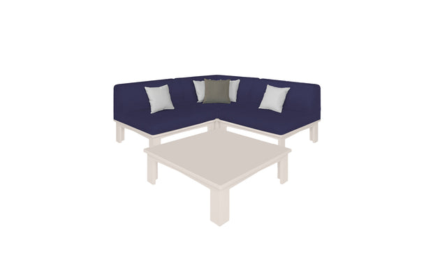 The Mainstay Sectional 4 Piece Diamond by Ledge Lounger features a modern L-shaped design in navy blue, complemented by white and gray cushions. It creates a cozy corner with a square beige coffee table, all stylishly isolated on a white background.