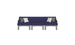 The Ledge Lounger Mainstay Sectional 3 Piece Sofa, a dark blue three-seater with gray legs and two white and gray throw pillows symmetrically arranged, enhances your outdoor space against a plain white backdrop.