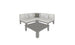 A minimalist Mainstay Sectional 4 Piece Diamond by Ledge Lounger features light cushions and cozy corner pillows—two white and one dark—beside a square gray coffee table, all on a white backdrop.