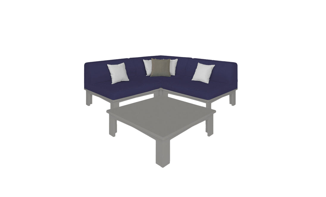 The Mainstay Sectional 4 Piece Diamond by Ledge Lounger, in navy blue, forms a cozy L-shaped corner with three white and one gray pillow. A gray coffee table sits in front of the sofa on a white background.