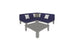 The Mainstay Sectional 4 Piece Diamond by Ledge Lounger, in navy blue, forms a cozy L-shaped corner with three white and one gray pillow. A gray coffee table sits in front of the sofa on a white background.