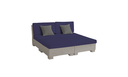 The modern low-profile double bed boasts a gray base with navy bedding and matching gray pillows. Set against a plain white background, its minimalist design mirrors the sleek, contemporary style of Ledge Loungers Signature Sectional 4 Piece Sun Chair, offering comparable relaxation.