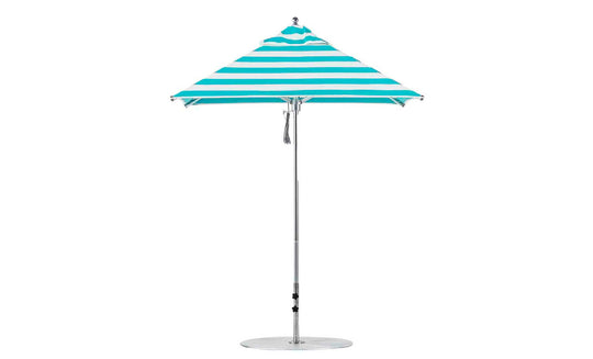 The Premier Aluminum Umbrella by Ledge Lounger features turquoise and white marine-grade fabric in a square design with a central silver pole, round base, and wind-resistant canopy that forms a conical shape. It is complemented by a small finial at the top.