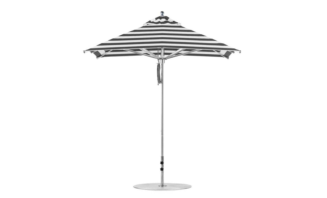 The Ledge Lounger Premier Aluminum Umbrella - 7.5 Square Pulley is a black and white striped outdoor umbrella with a pointed top, crafted from wind-resistant marine-grade fabrics, featuring a sleek metallic pole and sturdy round base.