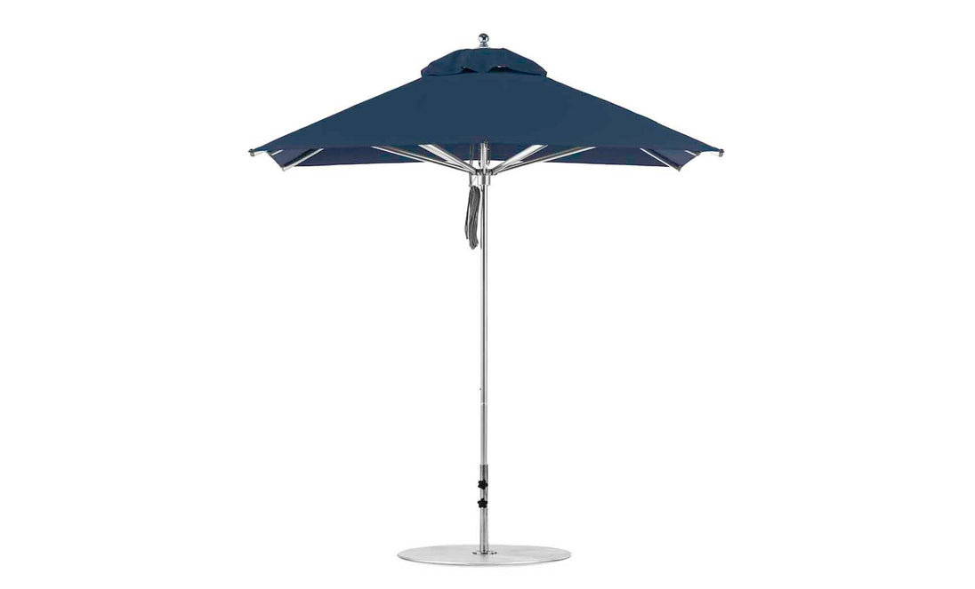 The Ledge Lounger Premier Aluminum Umbrella features a 7.5 square canopy and a sleek metal pole, secured with a strap. Made from marine-grade fabrics, this wind-resistant umbrella offers classic sun protection for outdoor areas.