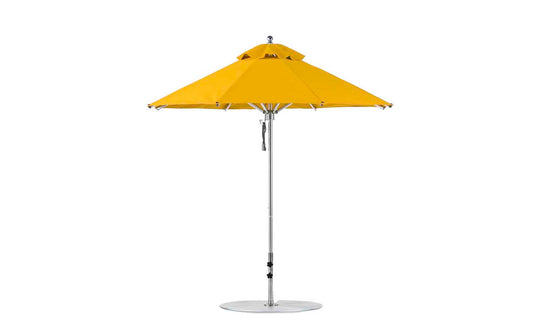 The Ledge Lounger Premier Aluminum Umbrella - 7.5 Octagon Pulley, in bright yellow, features a metal pole and circular base designed for outdoor use. It stands against a plain white background with marine-grade fabric, a classic wide-dome shape, and a peak vent for wind resistance.