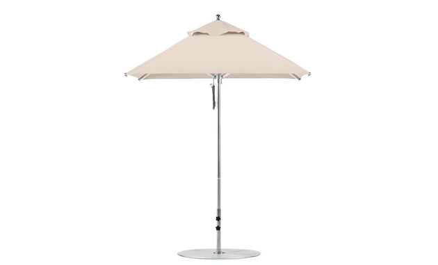 The Ledge Lounger Premier Aluminum Umbrella features a beige square canopy atop a silver pole with a circular base. Made from marine-grade fabrics, this umbrella includes a pulley system for easy adjustments and offers wind resistance for stability.