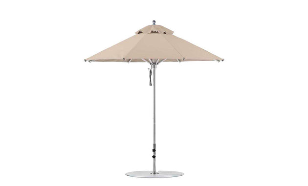 Discover the Ledge Lounger Premier Aluminum Umbrella - 7.5 Octagon Pulley, with a beige canopy and metal pole. It features marine-grade fabrics, a round base, and a vented top for air circulation, creating a wind-resistant design perfect for enhancing your outdoor oasis.