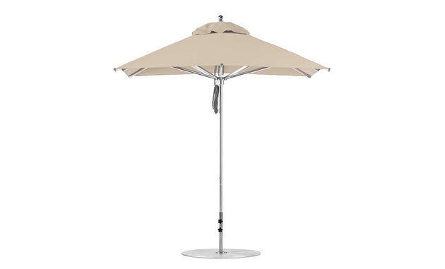 The Ledge Lounger Premier Aluminum Umbrella - 7.5 Square Pulley features a sturdy silver pole with a beige top and round base. Its vented design allows airflow, and its marine-grade fabrics enhance durability, making it wind-resistant and perfect for outdoor use.