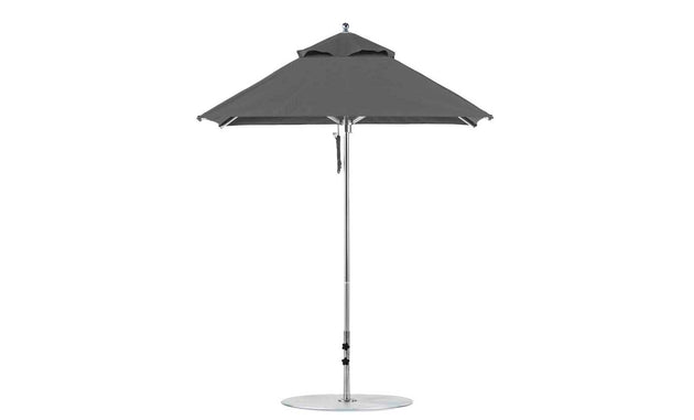 The Ledge Lounger Premier Aluminum Umbrella features a 6.5 square canopy made from marine-grade fabric for durability, mounted on a white pole with a round base. Its height-adjustable design is wind-resistant, ensuring stability and style with its vented top for enhanced airflow.