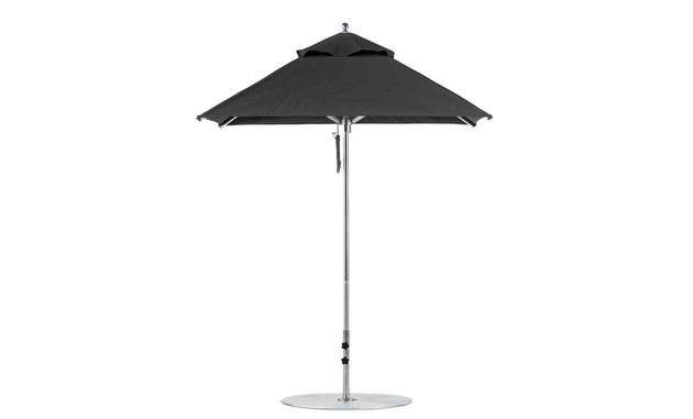 The Premier Aluminum Umbrella by Ledge Lounger, has a 6.5 square canopy crafted from marine-grade fabrics, features a central metal pole and circular base. Wind-resistant, its fully open and showcased against a white background.