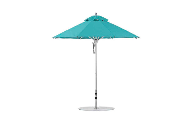 The Ledge Lounger Premier Aluminum Umbrella - 7.5 Octagon Pulley features a turquoise canopy, silver pole, and round base. Made with marine-grade fabrics, it offers a double vented design for superior wind resistance.