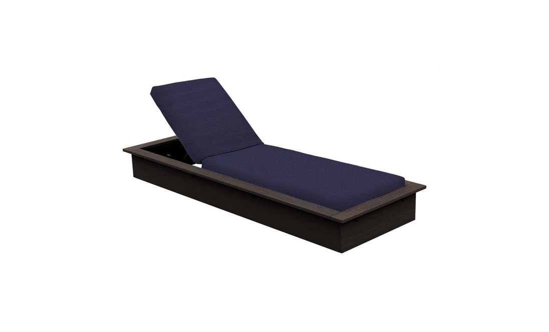 The Echo Chaise by Ledge Lounger is a modern, dark wooden lounger featuring a navy blue cushioned seat and backrest. Its perfect for enhancing any outdoor space and is shown against a white background.