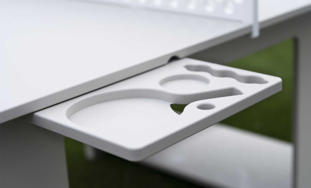 A close-up shows the Ledge Lounger Table Tennis Set holder attached to a table, featuring slots for two paddles and several balls. The grassy, blurred background enhances its outdoor entertainment appeal.
