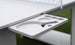 A close-up shows the Ledge Lounger Table Tennis Set holder attached to a table, featuring slots for two paddles and several balls. The grassy, blurred background enhances its outdoor entertainment appeal.