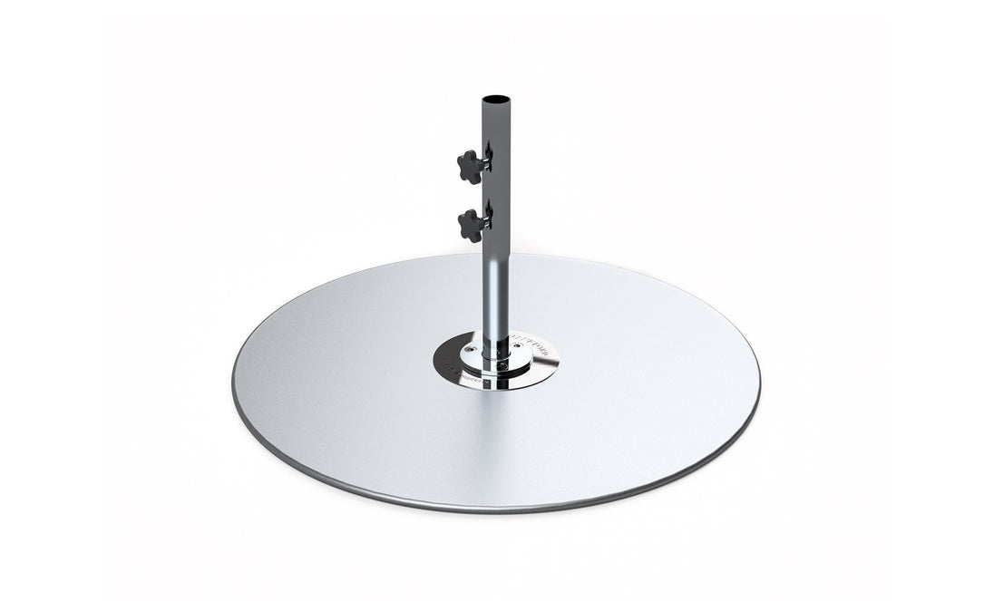 The Ledge Lounger Galvanized Steel Stack Umbrella Base features a round, shiny base crafted from galvanized steel supporting a tall central pole, perfect for center pole umbrellas. It includes two adjustable knobs for securing objects and fits seamlessly into any setting with its simplicity against a white background.
