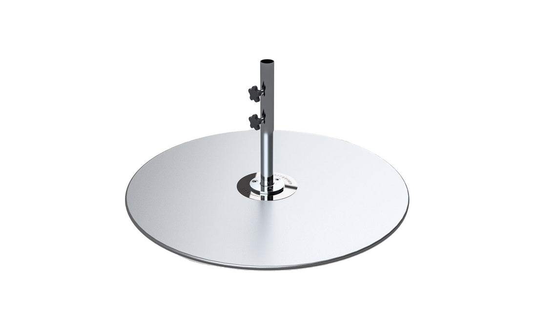 The Galvanized Steel Stack Umbrella Base by Ledge Lounger features a round, smooth silver design akin to a cymbal on a vertical stand with adjustable components similar to those in Traditional Umbrella Compatibility Matrices, perfect for minimalist aesthetics and musical purposes.