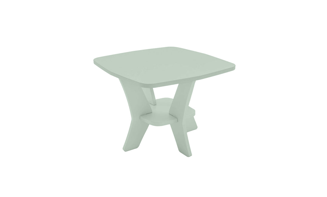 The Mainstay Square Side Table by Ledge Lounger is a compact, modern outdoor piece with a light green finish. It features a unique crossed-leg design, lower shelf for support, and all-weather durability, making it perfect for your patio.