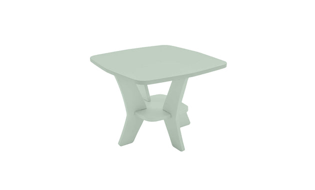 The Mainstay Square Side Table by Ledge Lounger is a compact, modern outdoor piece with a light green finish. It features a unique crossed-leg design, lower shelf for support, and all-weather durability, making it perfect for your patio.