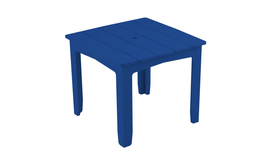 The Mainstay Square Dining Table by Ledge Lounger is a blue plastic table with a slatted top, four legs, and an umbrella sleeve at the center. Perfect for outdoor dining, its pictured against a plain white background.