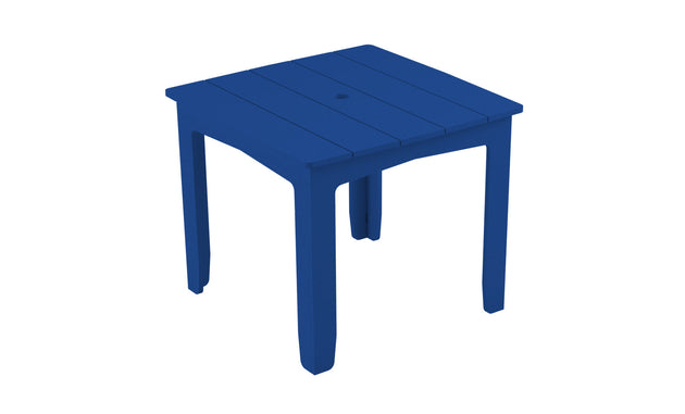 The Mainstay Square Dining Table by Ledge Lounger is a blue plastic table with a slatted top, four legs, and an umbrella sleeve at the center. Perfect for outdoor dining, its pictured against a plain white background.