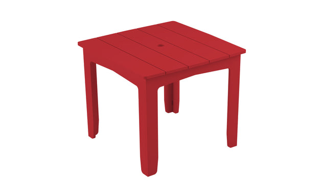 The Mainstay Square Dining Table by Ledge Lounger is a compact, red plastic dining table with a slatted top and four sturdy legs. Designed for outdoor use, it includes a central umbrella sleeve to provide shade and comfort.